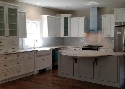 custom white kitchen with gray island